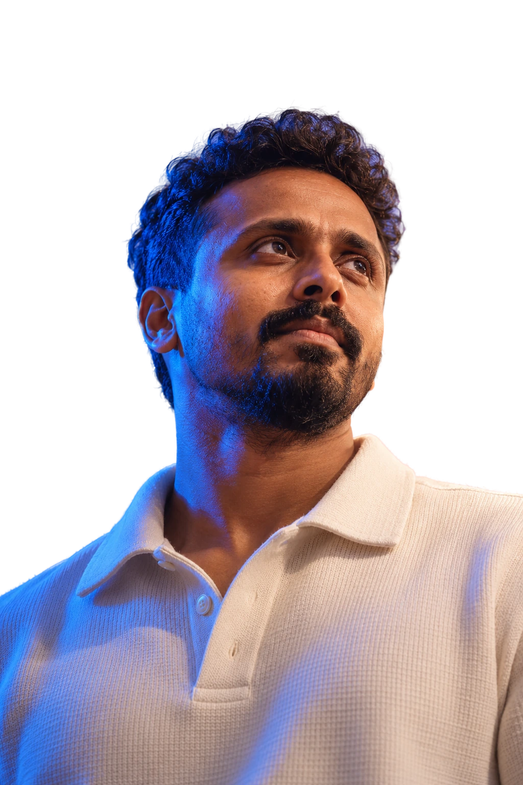 Portrait of Ananthu Sankar looking up, lit in blue and violet
